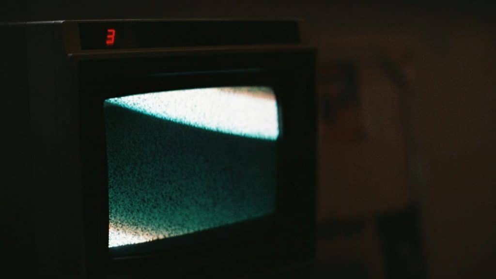 black crt tv turned on showing blue screen